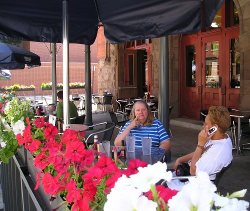 The girls sitting outside Bar Louis.