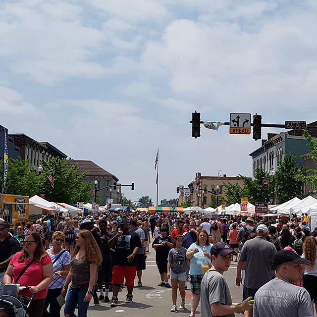 Street scene of hundreds of people in downtown Troy, Ohio, for the Troy Strawberry Festival.
